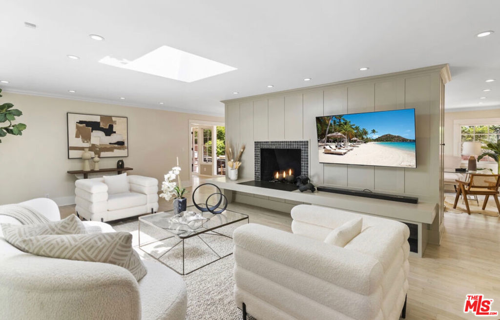 Nestled on a quiet street in the Beverly Hills Post Office, this newly remodeled single-level home is a private oasis offering comfort, style, and seamless indoor-outdoor living. With two spacious bedrooms, plus a versatile den ideal for a home office, and two elegantly appointed bathrooms, including a marble-clad primary suite with soaking tub and rain shower, the layout is thoughtfully designed for everyday ease. Sunlight pours through the skylights and large windows, illuminating the inviting living room with its hardwood floors and cozy fireplace. The chef's kitchen is equipped with quartz countertops, custom shaker cabinetry with built-in wine rack, and stainless steel Viking and Sub-Zero appliances. The home enjoys a new high efficiency air conditioning system and a new efficient gas hot water heater with circulation pumps. Outside is an entertainer's dream yard, where a sparkling pool, hot tub, and spacious patio invite year-round enjoyment. The front patio is fully enclosed and private, an ideal setting for morning coffee or evening drinks. Enjoy direct access to hiking trails in Franklin Canyon or a short 15-minute drive to the world-class shopping and dining of Rodeo Drive.