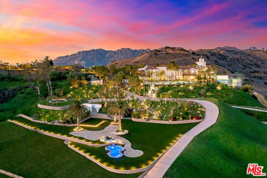 Introducing the iconic Malibu Dream Resort, a signature vineyard estate nestled atop its own secluded mountaintop. Spanning roughly 10,000 square feet, this grand residence echoes the lavishness of a classic Italian Villa, marrying timeless grandeur with the pinnacle of contemporary comfort. It offers unrivaled panoramic views of the Santa Monica mountains and the Pacific Ocean. Set within 45 untouched acres, and approximately 10 acres of flat land, the estate is approached via a private driveway, leading to the villa's grandeur. The interior boasts cathedral ceilings, polished hardwood floors, stone countertops, a professional-grade kitchen equipped with the latest appliances, and an additional prep kitchen. The master suite is a sanctuary of luxury with a spa-like bathroom, salon, and spacious walk-in closets for both. Accommodations include six plush guest suites, a media room, gym, and an expansive garage for eight vehicles. Outdoor living is redefined here with extensive stone terraces, a loggia with a fireplace and dining space, all extending to a spectacular pool and spa. This estate features the largest residential flat land in Malibu, enhanced by exquisite koi ponds, and offers views over Malibu's wine region and fruit orchards. The estate encompasses six individual parcels, showcasing its unmatched exclusivity. A dedicated house manager, with 25 years of service, resides in a separate guest house, ensuring meticulous upkeep. This estate is not only a magnificent residence but also presents an ideal opportunity for a retreat or treatment center, offering unparalleled privacy and luxury. For inquiries regarding short-term rental pricing and availability, please contact us. Discover the unique allure of this must-see Malibu estate.