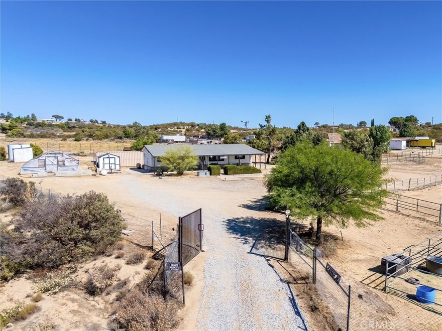 SIGNIFICANT PRICE DROP!!!  VETERANS - ASK ABOUT ASSUMING THE CURRENT VA LOAN - 3% Interest Rate!!!!!!!  Beautiful HORSE PROPERTY that's close to town, but not TOO close!!! Just 40 minutes or so from Old Town Temecula!!!  STUNNING VIEWS include GORGEOUS SUNRISES AND SUNSETS!!!!! Over 2.5 acres, FULLY FENCED, with HORSE CORRAL, LARGE ARENA, ROUND PEN, GOAT PEN, plus CHICKEN COOP, all for a price you can afford!!  The main residence is a comfortable 1,440 square feet and includes 3 bedrooms, 2 full bathrooms, plus an office/den (possible 4th bedroom).  Great Room off the entry has high vaulted ceilings, fireplace, and spacious kitchen with island.  Well has newer plumbing.  SHIPPING CONTAINER WILL STAY, so you have plenty of room for all of your stuff!!   Minutes from Cahuilla Resort and just a short drive to Wineries, Pechanga, Shopping, Galway Downs, and all that the TEMECULA VALLEY HAS TO OFFER!!!  This place will  serve as an ideal base for exploring all of SW Riverside County.  Make it your main home or a weekend getaway!!  Either way - YOU NEED TO JUMP ON THIS ONE BEFORE SOMEONE BEATS YOU TO IT!!!!!