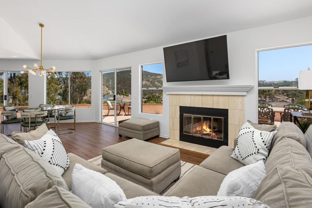 Beautifully renovated living at The Colony in Lake San Marcos! This impressive single-story home is located on a flat cul-de-sac and boasts gorgeous views with no rear neighbor directly behind. Upon entering, you'll immediately appreciate the abundant natural light, high ceilings, and endless views visible from both the interior and the spacious back patio. The home features an ideal layout with two suites on opposite sides. The living space includes a cozy fireplace, numerous windows, and doors that lead outside, enhancing the connection to the beautiful surroundings. The kitchen has been recently updated, with a wall removed to create a more open space, now flowing seamlessly into the dining/family room and patio, making it ideal for entertaining. It features a quartz countertop, custom backsplash, stainless steel appliances, an updated sink and faucet, a breakfast bar, and added window seating. The bathrooms have also been remodeled, showcasing exquisite marble showers, a modern vanity sink, and a walk-in shower. Additionally, new marble and vinyl flooring and new light fixtures have been installed in the home, and it has been freshly painted to showcase a light and bright atmosphere. Incredible views can be enjoyed from nearly every room, whether you're relaxing in the living area, enjoying coffee in the breakfast nook, or unwinding in one of the two primary suites. This home features an attached 2 car garage, gated entry front patio, along with an extra-wide wrap around back patio perfect for entertaining, pets, and relaxation. See supp. The generous, private outdoor living space provides stunning lake, mountain, and firework views! This truly is a peaceful retreat and a rare find. Residents of The Colony enjoy a Lake and Lodge Membership, which provides use of the clubhouse, pickleball courts, tennis courts, swimming pools, fitness center, billiards room, and access to the lake for fishing, kayaking, paddle boarding, boating, and more. Also located within this wonderful community are The Lakehouse Hotel and Resort, Brickman's Restaurant & Enoteca Restaurant Bar, dockside dining at Amalfi, The Canteen coffee shop, two golf courses, and neighborhood security makes this place your home sweet home!