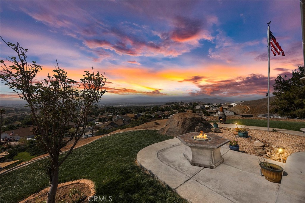 Welcome to 7871 Virtue Vista, a beautiful single-story home nestled within the exclusive Indian Hills Community. Perched atop a hill and secured by a private gate, this home offers unparalleled privacy and a million-dollar view of the Indian Hill Golf Course, city lights, and mountains as far as the eye can see. This home boasts 4 bedrooms and 2.5 baths, featuring an open and spacious floor plan with vaulted ceilings and beautiful hardwood floors throughout, creating a stylish and functional living space. You'll enjoy amazing views from the living, dining, family rooms, and kitchen. The updated kitchen is a chef's delight, complete with an island with a sitting area, stainless steel appliances, and a wine bar with a wine refrigerator. The living room, featuring a cozy fireplace, provides the perfect setting for family gatherings or relaxation. The spacious primary bedroom offers two closets and an ensuite bathroom with a dual sink vanity, a sunken tub, and a walk-in shower. The house has paid off solar panels and dual-pane windows enhance energy efficiency and fill the home with natural light, making it feel bright and inviting. Step outside to the covered patio, an ideal spot for dining and lounging while enjoying the serene views. Additional features include a convenient indoor individual laundry room with sink, an attached two-car garage, solar panels, ample room for RV, trailer and boat parking, an above ground sports workout spa, an above ground deck, BBQ Island, firepit and 6 individual storage sheds. This home offers the perfect blend of privacy and serenity, all while being just minutes from shopping and essential amenities. No HOA Fees. No Special Assessments Fees. With its perfect combination of luxury, comfort, and location this one of a kind amazing home is ready to call HOME!!