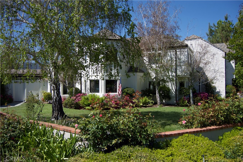Nestled on over an acre in one of Agoura Hills’ most desirable cul-de-sac enclaves, this impressive residence spans approximately 4,726 square feet with 5 bedrooms and 4 baths.
A grand, light-filled foyer greets you as you enter, flowing into a formal living room and framed by soaring ceilings and generous windows. Beautiful hardwood, stone, and tile finishes run throughout. The formal dining room includes a butler’s pantry for convenience. In the heart of the home, the chef’s kitchen features stainless appliances, granite countertops, a walk-in pantry, and a cozy breakfast nook that opens seamlessly to the family room, complete with a stone fireplace and views out to the yard.
On the main floor, there is also a guest bedroom with an en suite and a dedicated office or study, perfect for work-from-home needs. Upstairs, the primary suite offers a private balcony, serene views, a stacked-stone fireplace, and a luxurious spa-style bath with a large walk-in closet, soaking tub, and separate shower. Two additional well-sized bedrooms complete the upper level.
The outdoor living experience is exceptional: expansive patios and stone decking ideal for entertaining, a built-in BBQ center, brick-accented swimming pool and spa, lush gardens, and expansive lawns. A fully lighted north/south tennis court and an oversized 4-car garage round out the amenities.
With its enviable location, elegant appointments, and vast outdoor space, this property embodies refined Southern California living.