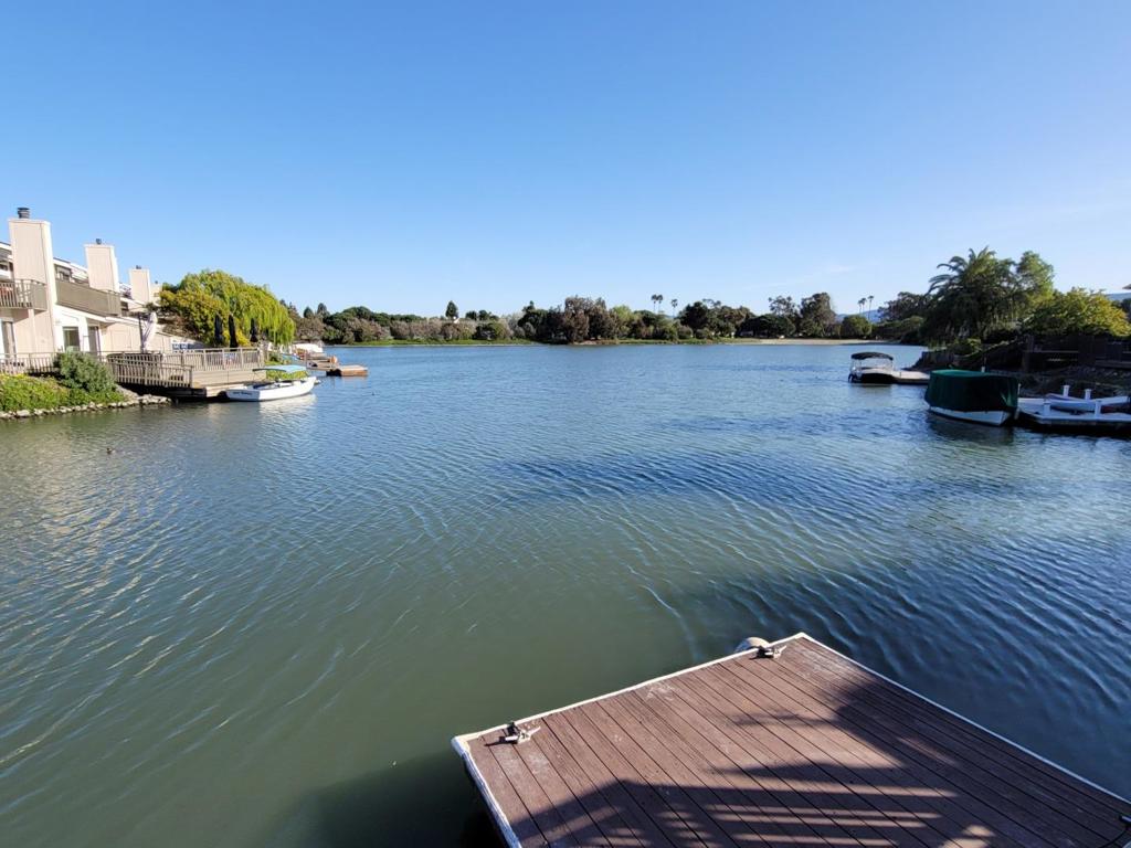Opportunity to enjoy resort-style-living in desirable Redwood Shores! Spacious, WIDE WATERFRONT, 3 bedrooms, 2.5 baths townhouse, offering 1,960 sq. ft. of living space with your own SPACIOUS DECK and BOAT DOCK to enjoy water sports. Includes community pool & tennis courts. Cathedral ceilings gives it an expansive feel. Upgraded in recent years. Hardwood floor on main level. One bedroom and powder room on the first level. Two master suites on the upper level. Located on a quiet cul de sac. Walk to Marlin Park which has 2 tennis courts and soccer field Appreciate waterbirds, wildlife and nature as you walk, bike or jog on the levee. Excellent schools. Conveniently located between San Francisco and Silicon Valley. Easy access to 101 and 92. No pets, please. Close to Bay Club, Nob Hill Market, shops and restaurants. NO PETS, pls. NO SMOKING.