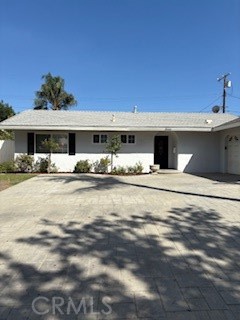 Wonderful location that is central to park, commute, shopping & schools. Updates throughout including newer hardwood-style flooring, new paint, central heat & A/C, dual paned windows plus slider, attached garage and paver-stone driveway. Kitchen has granite counters, large eating bar area, gas stove, dishwasher, double sink, white cabinets, tile floors, newer refrigerator and direct access to garage with laundry hook-ups. Hall bath has refinished tub + surround, large sink cabinet and tile flooring. The master bedroom en-suite, has walk-in closet and attached bath including tiled shower stall, pedestal sink, mirrored cabinet and tile floors. Additional bedrooms have walk-in closets and look over private fenced yard. Living room opens to kitchen eating bar and sliding door has access to large patio and grassed yard. Oversized driveway has plenty of room for off-street parking.