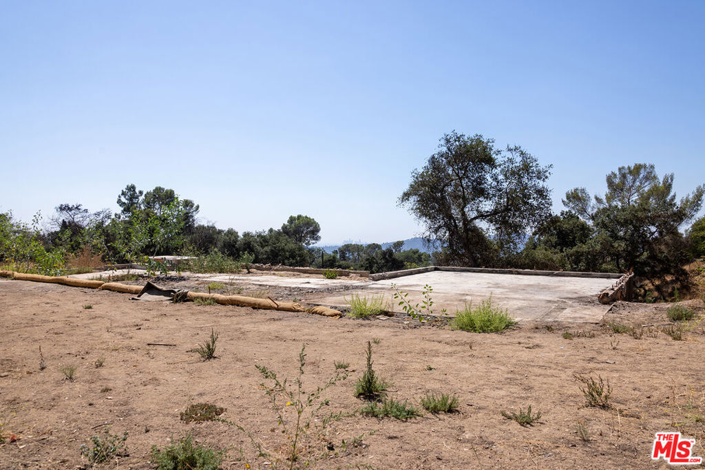 The current owners were originally drawn to 3635 Skylane for its tranquil yet accessible setting, the amount of space and potential the property offered, and its eponymous views that stretch out toward and past the downtown LA skyline. The location allows you to feel as if you're living in the wilderness without being isolated, with Altadena and Pasadena just a short drive away. There's easy access to many hiking trails, including Echo Mountain and Mount Wilson, which offer spectacular views of Catalina and the Pacific. Despite the loss of the home itself (4 Bed + 3 Bath + 3439 sq ft) during the Eaton Fire, some of the property's most desirable assets still remain, and someone with a similar vision can bring it back to life. The sellers had recently added a 40' long pebble finish pool with a 25' baja and a 7' square spa, a custom sport court with overhead lighting, and a new privacy gate. Fencing has been installed to give the new owner clear definition of the lot lines. With nearly 2/3 of an acre set above Loma Alta, 3635 Skylane Dr offers a great deal of privacy for those seeking a place to build their own unique retreat. This quiet enclave has historically been protected from the nuisance of road noise, highways, and public transport, has been populated by friendly and unique neighbors, and feels even more expansive than it is thanks to its open views of the surrounding mountains. This property (and the majority of the street/area) is on Septic. All utilities except gas were available prior to the fire. Phase 1 and 2 debris removal are complete and permitted. Buyer to do their own due diligence and investigations with LA County as to zoning, permitting, and any future building on the property.