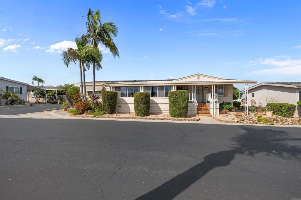 Introducing this beautiful, well maintained 2 bedroom, 2 bath mobile home in the 55+ community of the highly desirable Palomar Estates East. NO PROPERTY TAXES! The home offers 1344 square feet and an expansive sunroom that floods the living space with natural light-perfect for relaxing, entertaining or creative pursuits. The upgraded kitchen has modern finishes with stainless steel appliances, a pantry and an island with a brand new cooktop. There are 2 main living areas plus a dining room area, with lovely plantation shutters and ceiling fans throughout the home. The primary bedroom boasts lots of storage with a walk-in closet and an additional closet with shelves. There is a front patio to enjoy the view of the hills, perfect for relaxing! Additional outdoor highlights include lemon trees, palms trees, a covered carport accommodating 2 vehicles and a large storage shed. The community is a land leased park under rent control with lots of amenities including a heated pool, spa, saunas, dog park, community garden, tennis/pickle ball courts, gym, car wash, putting green, bocci ball, RV storage, activities for the seniors and more! The home is on an annual registration in lieu of property taxes. This home is a standout opportunity for anyone seeking a relaxed, coastal-inspired lifestyle with modern comforts. Enjoy the convenience of nearby shopping, freeway access and approximately 8 miles to Carlsbad beaches. Space rent is $611.23/ month.