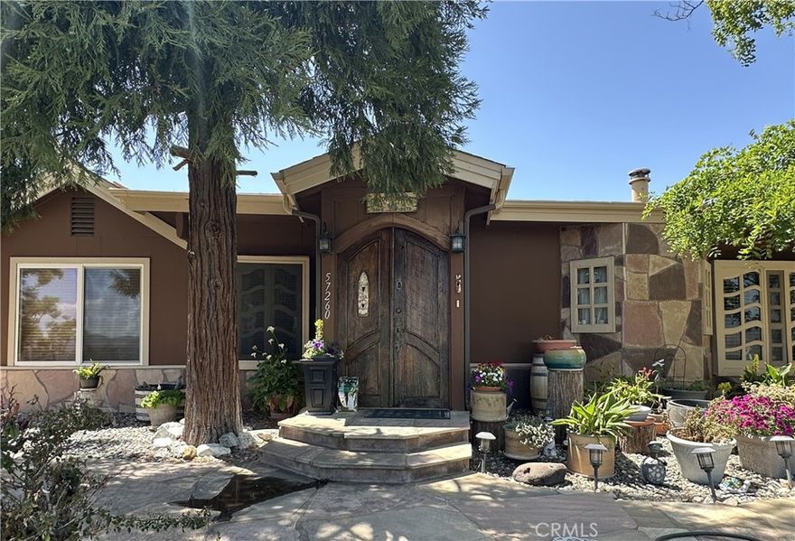 Welcome to this charming,  one-of-a-kind 2,757 square foot custom pool home set on 9.37 scenic acres located on a PAVED road in Anza. Thoughtfully designed, this spacious residence offers 3 bedrooms and 3 bathrooms, with 2 bedrooms and 2 baths located on the main level, and a fully finished basement that adds a third bedroom, additional bathroom, a laundry room, and a generous bonus space ideal for a game room or secondary living area. Enter through a charming custom arched doorway into an open living room featuring a cozy fireplace, which flows seamlessly into the open country kitchen. The kitchen showcases rustic wood countertops, cabinetry, and exposed wood ceiling beams that enhance its warm, inviting feel and is equipped with a Jenn-Air gas stove with optional griddle and grill options, and an electric convection oven. Adjacent to the kitchen, the dining area is adorned with unique custom windows and a wood-burning stove—perfect for intimate family meals. The  family room offers a second wood-burning stove, striking custom windows, open-beam ceilings, and a sliding glass door that leads out to the expansive pool area, offering breathtaking valley views. A convenient half bath is located just off the family room. On the lower level, you’ll find a large walk-in pantry and storage area, along with a full bathroom that includes direct outdoor access—an ideal setup for outdoor entertaining and poolside gatherings.  There is also a small fenced orchard that includes peach, pear, apple, plum and apricot trees and a separate small fenced area with both red and green grape vines.

Located minutes from town, this property offers easy access to local amenities such as Post office, gas stations, unique diners, fast food options, a hardware store, casino and Hamilton High School in the Hemet School District. It's situated 13 miles south of Idyllwild, east of Temecula, and southwest of Palm Springs, approximately 75 miles from San Diego via State Route 371.