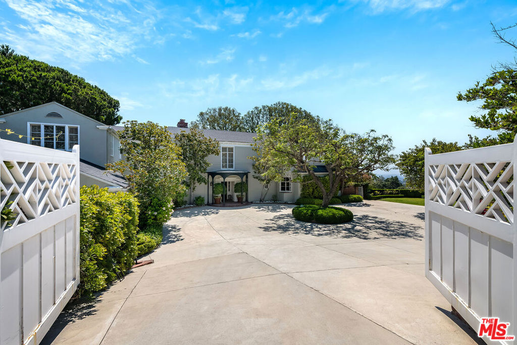 Iconic house and property in a prime lower Bel Air location. Now with interior photos! James Dolena timeless architecture with grand scale and volume, great rooms, a classic floor plan all with elegance and style and designed for entertaining. Sweeping city and ocean views draw you from the inviting entry out to the expansive back yard bringing the outside in from each of the downstairs entertaining rooms. Mahogany wood paneled library is both intimate and welcoming and in between the library and the large formal Living Room is a sun room with a wet bar all leads back to the large foyer. Large formal Dining Room including a separate junior dining room also incorporate stunning views of the yard and vistas over The Bel Air Country Club golf course out to Palos Verdes and Santa Monica. Down stairs office, kitchen with a large butlers pantry, large laundry room and staff quarters complete the lower level of this home. Large primary suite with an office, dual baths and dressing rooms is private and intimate. Upstairs den opens to a large balcony which overlooks the property and takes advantage of the views and the extraordinary trees. Two additional family bedroom suites plus a 3rd which has been converted to a work out space is the ideal size for either an upstairs office or a nursery. Separate guest house with a walk in closet and full bath as well as a kitchenette, wine cellar, cold storage room plus a 5 car garage. Very large swimmers pool, cabana and a north south lighted paddle tennis court take complete advantage of the golf course views and complete this magical and legendary property. Street to street lot, meandering paths, beautiful trees and privacy, the hallmark of a very special lifestyle. This truly is a great house... and with updating this will make the next homeowner as happy as it has made the current homeowner.