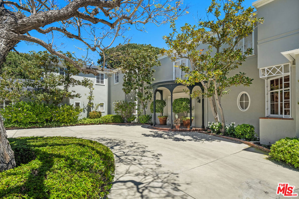 Iconic house and property in a prime lower Bel Air location. James Dolena timeless architecture with grand scale and volume, great rooms, a classic floor plan all with elegance and style and designed for entertaining. Sweeping city and ocean views draw you from the inviting entry out to the expansive back yard bringing the outside in from each of the downstairs entertaining rooms. Mahogany wood paneled library is both intimate and welcoming and in between the library and the large formal Living Room is a sun room with a wet bar all leads back to the large foyer. Large formal Dining Room including a separate junior dining room also incorporate stunning views of the yard and vistas over The Bel Air Country Club golf course out to Palos Verdes and Santa Monica. Down stairs office, kitchen with a large butlers pantry, large laundry room and staff quarters complete the lower level of this home. Large primary suite with an office, dual baths and dressing rooms is private and intimate. Upstairs den opens to a large balcony which overlooks the property and takes advantage of the views and the extraordinary trees. Two additional family bedroom suites plus a 3rd which has been converted to a work out space is the ideal size for either an upstairs office or a nursery. Separate guest house with a walk in closet and full bath as well as a kitchenette, wine cellar, cold storage room plus a 5 car garage. Very large swimmers pool, cabana and a north south lighted paddle tennis court take complete advantage of the golf course views and complete this magical and legendary property. Street to street lot, meandering paths, beautiful trees and privacy, the hallmark of a very special lifestyle. This truly is a great house... and with updating this will make the next homeowner as happy as it has made the current homeowner.