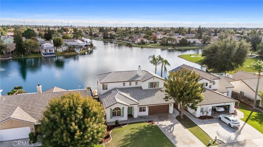 Discover the rare opportunity to own a lakefront sanctuary right in the city - where every day feels like a vacation! This exceptional property offers an unparalleled lifestyle with a short walk to the golf course and direct access to the 17-acre lake perfect for kayaking, boating, and fishing - all just steps from your back door. This will be an oasis for family and friends alike as they enjoy with you the breathtaking lake and sunset views that paint the sky in the evenings, creating the perfect backdrop for relaxation or entertaining. With 5 pocket parks, lakeside walking paths, unique access to the private clubhouse and resort-style pools and Jacuzzis, you'll experience the unique blend of serenity and sophistication that simply can't be found anywhere else in the city. With a unique downstairs Jr. suite, open concept kitchen, and two separate spacious living areas, this home is ready to be enjoyed! Embrace the extraordinary and make this rare LAKE HOME your everyday retreat!