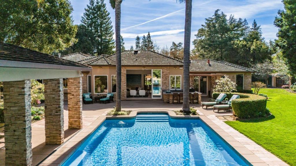Experience the epitome of California living in the meticulously remodeled estate, nestled on over an acre of lush lawns, mature trees and vibrant foliage. The property includes a charming 1 bedroom guest house with full kitchen, living room, office and guest suite. The main residence features three luxurious bedroom suites, a formal dining room, family/game room and gourmet kitchen/living area. Step outside into your private resort-like oasis, complete with a stunning pool, outdoor kitchen, basketball court and putting green. Located in the highly sought-after Menlo Park school district.