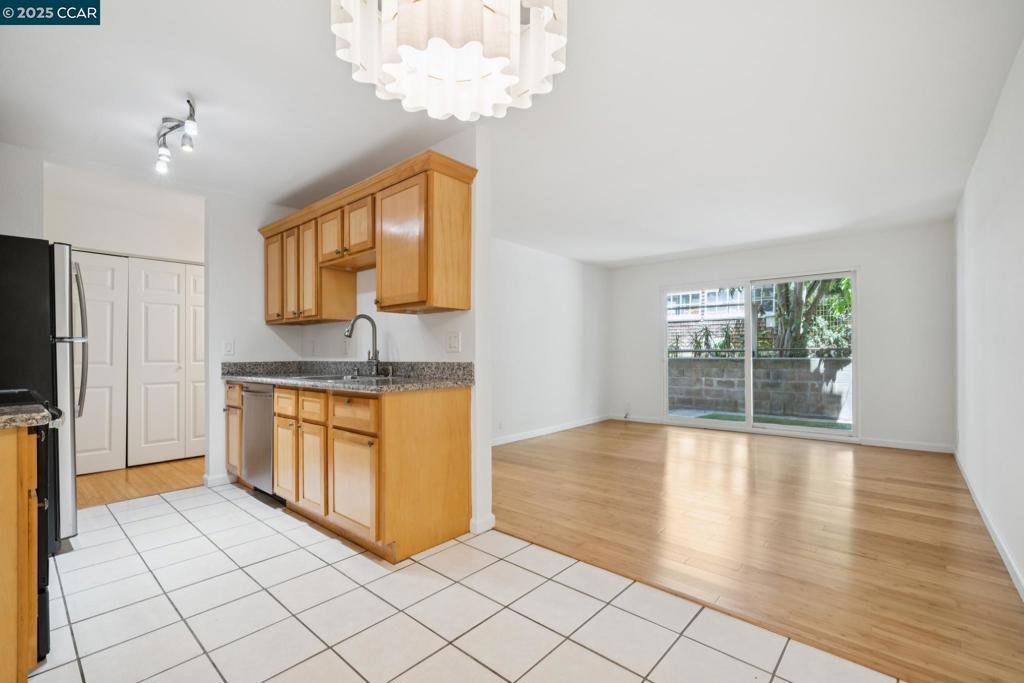 Tucked away from the street in a quiet, well-maintained community, this ground-floor corner unit at 150 Pearl Street offers a peaceful retreat in the heart of Oakland. Thoughtfully updated and move-in ready, the home features sleek bamboo flooring throughout, newly installed lighting, and a private patio—ideal for al fresco dining or a morning coffee. The modern kitchen is equipped with newer stainless steel appliances and ample cabinetry, perfect for everyday cooking or entertaining. Just off the entry, a convenient closet offers flexible storage—ideal for coats, extra pantry items, or household essentials. The bedroom includes a generous closet and a built-in office alcove, making the most of its efficient layout and providing a great space for remote work or study. The refreshed bathroom features a shower-over-tub combo along with a new sink and toilet. Additional highlights include secure, assigned parking and easy access to freeways, shopping, dining, and transit. Enjoy close proximity to the vibrant Piedmont Avenue shopping district and scenic Lake Merritt—two of Oakland’s most beloved neighborhoods. Whether you're a first-time buyer or looking to downsize, this home blends comfort, style, and a prime central location.