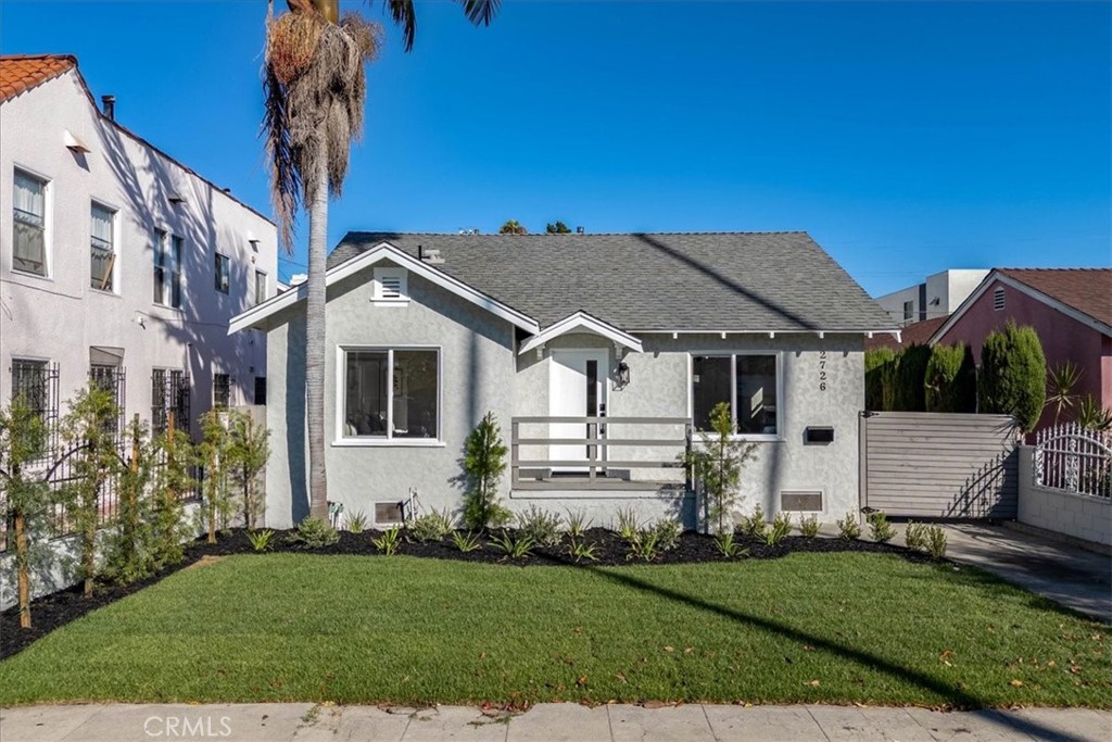 Timeless cottage-style architecture meets thoughtful modern updates, a beautifully refreshed 2-bedroom, 1-bath home located in the heart of West Adams. Set on a picturesque, tree-lined street, this light-filled residence blends original charm with today’s comforts, creating the ideal balance of character and convenience. Inside, natural light fills every room, highlighting the wide-plank laminate flooring and open, airy layout. The updated kitchen is a true standout—featuring quartz countertops, classic white shaker cabinets, a large kitchen island for entertaining or casual dining, a 6-burner range, and an inviting family room that invites you to slow down and savor your evenings. Ceiling fans in the bedrooms add comfort, while central air and heat ensure year-round climate control. A dedicated laundry room with space for a washer and dryer adds everyday functionality. Each bedroom is generously sized, and the full bathroom is centrally located for easy access. But the real magic continues outdoors—step into a spacious backyard that feels like your own private park. With mature citrus trees that produce an abundance of fruit, it’s the perfect setting for weekend lounging, gardening, or entertaining under the stars. Located just blocks from local favorites like Highly Likely Café, Cento Pasta Bar, Whole Foods, Target, and the Farmdale Metro Station, this home offers the lifestyle today’s buyers are looking for—charm, upgrades, space, and access to the best of LA living.