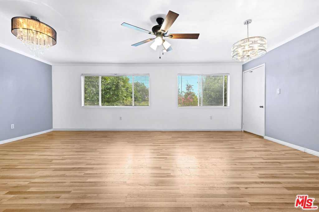 Embrace modern living in this chic 2-bedroom, 1-bath condo, perfectly nestled in the heart of Studio City. This top floor unit offers privacy and treetop views to enjoy from your windows and balcony. The kitchen is a culinary delight with stylish cabinets, quartz countertops, and stainless steel appliances. The living area is beautifully illuminated by recessed lighting and a striking chandelier, creating an open and inviting atmosphere. The primary bedroom includes a newly installed ceiling fan and recessed lights, along with a spacious walk-in closet. A secondary room features its own closet and versatile layout, ideal for use as a guest bedroom or home office. Enjoy the peace of new vinyl plank flooring throughout, designed to minimize noise. The bathroom boasts upgraded features, including a new bathtub, ceramic tiles, stylish fixtures, and a modern vanity. Thoughtful touches like a newer HVAC system, a new closet in the second bedroom, and fresh hallway cabinets add convenience and flair. Community perks include a heated pool, sauna, two parking spaces, laundry facilities on each floor, and secure access. Conveniently located just steps from The Shops at Sportsmen's Lodge, Ventura Blvd, Ralph's, Whole Foods, and Fryman Canyon, with easy access to the West Side, this move-in-ready condo is your stylish retreat in Studio City.