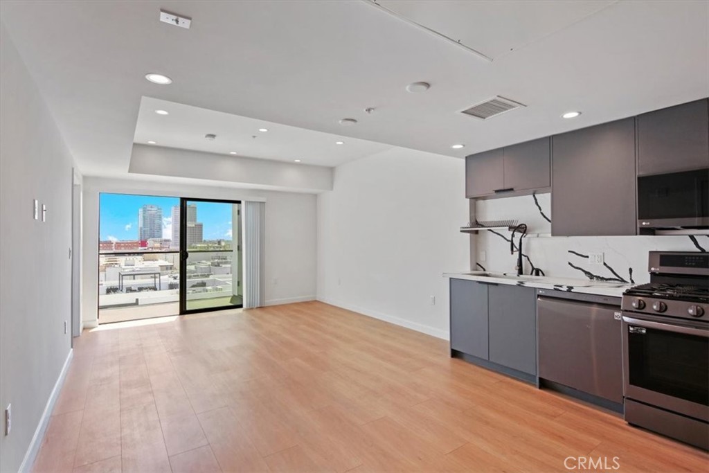 Penthouse 2BD/2BA – Top Floor Luxury Condo in the Heart of Koreatown! Experience elevated living in this top-floor penthouse with no one above you and unmatched panoramic views. This south-facing unit is drenched in natural light, creating a bright, airy atmosphere throughout the day. Located in a secure, modern 38-unit building, this 2-bedroom, 2-bathroom condo offers high-fashion architecture, a center courtyard with glass railings, and a fully equipped fitness center. Enjoy an open-concept floor plan with a spacious private balcony, perfect for taking in the city skyline views. The luxury kitchen is outfitted with stylish finishes, warm wood flooring, and premium appliances, including a refrigerator, dishwasher, microwave, and stove range—all included. Special 2-1 buydown financing available for below 5% interest rate! Additional highlights: thoughtfully designed interiors for comfortable, modern living | Safe, well-maintained building with top-notch security | Prime Koreatown location | 2 blocks from California Market | across the street from YMCA with gym & pool | close to Wilshire/Western Metro Station. Walk to top dining, shopping, and entertainment. Come see it for yourself!