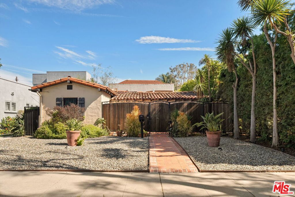 Venice Spanish Charmer with Guest Units & Artistic Flair.  Discover this enchanting 1929 Spanish-style gem ideally located in the heart of Venice. Step into a sun-drenched living room featuring a stunning barrel ceiling and classic wood-burning fireplace, with French doors opening to a private, enclosed front patio...perfect for morning coffee or evening gatherings. The spacious formal dining room flows into a partially upgraded kitchen, ideal for entertaining or everyday living. Beautiful hardwood floors run throughout, adding warmth and character to every room. A back door leads to a covered patio and a fully detached two-story auxiliary structure. The upper level offers a bright, open-concept loft-style guest unit with soaring wood-plank ceilings, exposed truss beams, skylights, and French doors leading to a private wood deck. With its abundance of natural light and artistic design, this flexible space is perfect for a creative studio, home office, or guest retreat. Downstairs, a separate unit features a cozy bedroom, sitting area, and bath offering even more versatility for guests, extended family, or rental income potential. This exceptional Venice property blends timeless Spanish charm with modern flexibility...an ideal opportunity in one of L.A.'s most vibrant coastal communities.