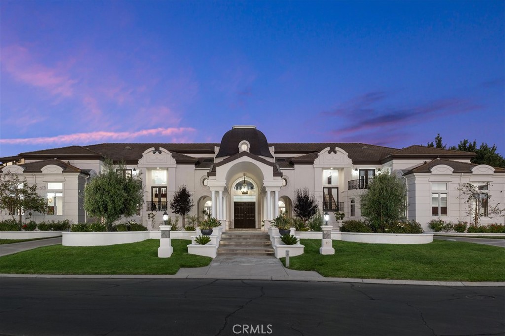 Welcome to one of Coto de Caza’s most distinguished addresses—an extraordinary custom estate in The Woods, one of the community’s most coveted and picturesque neighborhoods, ideally located near the exclusive Coto de Caza Golf & Racquet Club.
Set on a sprawling ~49,860 square foot lot, this magnificent ~12,680 square foot residence was masterfully crafted with steel construction and designed to impress at every turn. A grand semi-circular, dual driveway with a porte cochere leads to an imposing three-story entry crowned by an exterior copper dome, setting the stage for the home's blend of classic elegance and modern luxury.
Inside, you’ll find 6 bedrooms and 11 bathrooms across a truly remarkable floorplan built for both intimate living and grand-scale entertaining. The dramatic family room evokes a two-story European cathedral with soaring ceilings, extensive custom moldings, and a massive fireplace. The formal dining room is equally elegant, complete with its own fireplace for warm, memorable gatherings.
For effortless entertaining, the home features a dedicated game room (perfect for billiards, shuffleboard, ping pong, and darts), a full bar with wine closet, and an independent theater/screening room. The gourmet kitchen is designed to handle events of any scale, featuring an expansive butler’s pantry and separate food prep area ideal for a private chef or service staff.
Additional highlights include three staircases, two full laundry rooms, multiple offices, a dramatic two-story library, and even a separate walk-in vault/safe room. The expansive side motor court with an electric gate provides ample secure parking in addition to the 5-car garage.
Owned solar panels with a 25-year warranty offer modern efficiency, while the grounds are perfectly suited for hosting large-scale events—from weddings and galas to unforgettable family reunions.
This is not merely a home, but an estate that stands apart from all others in Coto de Caza—a rare opportunity to own one of the community’s true showpieces.