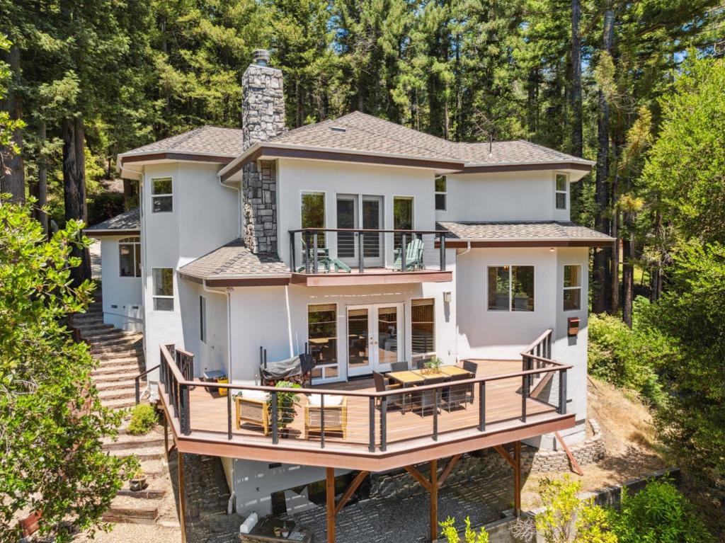 Picture yourself in a home tucked conveniently between the technological hub of Silicon Valley and the scenic beaches of Santa Cruz, nestled in a beautiful Redwood forest. This is it! Experience mountain living in the comfort, style, and serenity of 716 Dry Well Road. Built in 2000 on 3.5 wooded acres, this spacious, 4-bedroom, 2-½ bath home is truly one-of-a-kind, offering spaces ideal for a home office, music room, or simply unwinding. The abundance of windows floods the interior with natural light and showcases stunning vistas of the surrounding redwoods and mountain landscape. The expansive open kitchen features a spacious pantry, ample granite counter space, and peaceful forest views. Relax in the luxurious primary bedroom suite, complete with a spacious closet, an ensuite with dual vanities and generous storage, and a sunken retreat leading to a private deck. Venture out from the family room onto the large south-facing deck and immerse yourself in forest scenery, birdsong, wildlife, and the crisp mountain air. The home also includes a substantial 3.5 car garage with extensive built-in storage and workspace. Experience a one-of-a-kind redwood mountain haven at 716 Dry Well Road.