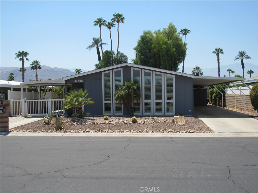 Fully remodeled beautiful home in Portola Country Club! The owner was meticulous in the renovation, making sure that each detail was as expected. This spacious 2 bedroom/2 bath home features an expanse great room with lots of light and plantation shutters. The laminate floors are in excellent condition and resemble real wood. You can hardly tell the difference and the color suits the home well. The kitchen is fully updated with stainless steel appliances which include a gas cooktop, built-in double oven, microwave and dishwasher. The stainless steel farmhouse sink adds a final touch. The kitchen has ample counter space and is surrounded by bar seating. The pantry is magnificent! The walk in pantry features appliance shelves with electrical outlets where you can store your counter appliances until needed. Simply walk into the pantry and use these appliances without having to pull them out or clutter your countertops. The laundry room, in a similar way, has utility cabinets with electrical outlets inside so that your cleaning appliances can remain plugged in and charged, but yet hidden out of sight until needed. There is also a washer and dryer and utility sink. Both bedrooms in the home are spacious and feature plantation shutters and ceiling fans. The primary bedroom has a California Closets organization system with beautiful frosted glass doors and an ensuite bathroom with soaking tub, separate walk-in shower and double vanities. The secondary bedroom is also large in size featuring the same closet organization system. The secondary bathroom contains a walk-on shower. The home also features a covered carport, storage shed and golf-cart parking. The home is professionally landscaped and the side yard has been converted into a relaxing oasis complete with awning. The home is uniquely managed with solar electricity. The solar panels are fully owned and will be the property of the new owner (no lease). The solar battery storage system is neatly tucked away in the carport and the reduction in electrical costs is significant. One of the major features in Portola Country Club is that you own the land! The community features three pools and spas, a clubhouse, and 18-hole gold course (free to two residents per household), tennis courts, pickleball courts and a dog park. The low HOA fee covers high speed internet, satellite television and trash. This home and the community are conveniently located close to shopping, restaurants and the well-known El Paseo Drive.