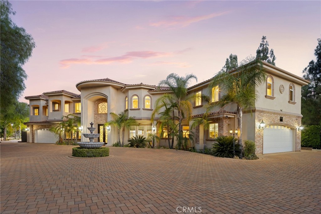 Discover refined living in this stunning custom-built estate located in the exclusive gated community of Hidden Hills West. Set on over an acre of lushly landscaped grounds, this private sanctuary offers more than 9,000 square feet of meticulously crafted living space—designed with timeless quality, elegance, and functionality in mind. The estate features 7 spacious bedrooms, each with en-suite bathrooms and custom walk-in closets, seamlessly blending architectural sophistication with modern comfort. The grand entryway foyer showcases a hand-painted domed ceiling, handcrafted chandelier and a custom dual iron-leaf staircase, leading to the upper level. Just beyond, the formal living room features floor-to-ceiling windows that flood the space with natural light. A refined formal dining room off the foyer includes a dual-glass butler’s pantry—perfect for displaying fine china and stemware. The layout includes a private guest suite with its own entrance and living space, perfect for extended stays, multigenerational living, or live-in staff. Upstairs, enjoy a state-of-the-art surround sound home theater with built-in seating, a game room, and private gym. At the heart of the home, the gourmet kitchen is a chef’s dream—fully equipped with top-of-the-line built-in Viking appliances, six burner stove, double ovens, custom cabinetry, and a spacious center island. Step outside to discover resort-style amenities including a private sports court, putting green, multiple outdoor entertaining areas, a covered oversized patio, and an outdoor kitchen—framed by manicured landscaping that ensures total privacy. Thoughtfully designed and built by the current owners with longevity in mind, this estate rests on a durable post-tension slab foundation—ensuring structural integrity for generations to come. Premium features such as double-pane Milgard windows, Emtek hardware, and high-quality pavers lining both the front driveway and rear patio further reflect the home's commitment to lasting quality and timeless design. Enjoy the luxury of two oversized garages with covered parking for up to four vehicles, built-in electric vehicle charging ports, and solar panels that sustainably power the entire property—designed for modern, eco-conscious living. Located just minutes from The Commons of Calabasas, this hidden gem offers the rare combination of privacy, convenience, and lasting quality.