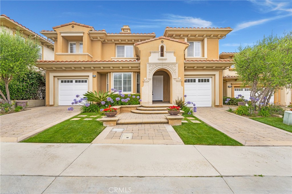 Discover refined coastal living in this elegant 3,786 square foot single-family home, located in the prestigious guard-gated Ritz Pointe community. Offering 24-hour security and direct access to scenic walking trails leading alongside the Monarch Beach Golf Course toward Salt Creek Beach , this home combines luxury, privacy, and an unbeatable location. A portico entrance with an oversized front door sets the tone for the home’s grand interior. Upon entry, you're welcomed into a formal living room with a warm fireplace and travertine flooring that flows seamlessly throughout the main level. Adjacent to the living room is a formal dining area illuminated by a classic chandelier, perfect for hosting gatherings. The heart of the home is a generous open-plan family room that connects effortlessly with the dining space and chef’s kitchen. The kitchen features a large island with a six-burner gas range, granite countertops, newly painted cabinetry, double ovens, a Sub-Zero refrigerator, microwave, and a spacious walk-in pantry. A convenient powder room is also located on the lower level. Upstairs, the expansive primary suite serves as a peaceful retreat, complete with its own fireplace & a charming Juliette balcony overlooking the private oasis backyard. The spa-like primary bathroom includes a soaking tub, large walk-in shower with built in bench, multiple shower heads, dual sink vanities, & a custom walk-in closet with built-in shelving & drawers. Three additional upstairs bedrooms offer comfort and privacy,one with ensuite full bathroom & two sharing a Jack & Jill bathroom. A versatile upstairs bonus area & an additional space ideal for a home office provide flexible options for work or leisure. Additional highlights include a three-car garage (featuring one single & one tandem two-car configuration), ample driveway parking, a separate indoor laundry room with sink & cabinetry. The landscaped & private backyard space includes a classic outdoor fireplace that adds warmth and charm, water features and a built in BBQ & Bar area perfect for entertaining. This stunning home offers the best of coastal Southern California living, ust minutes from Salt Creek Beach, the Ritz Carlton, Waldorf Astoria, Dana Point Harbor, and the vibrant "Lantern District" with restaurants, shops, and entertainment. Also conveniently close to Ocean Ranch Shopping Center with Trader Joe’s, Starbucks, and Cinepolis Luxury Cinemas. This is a rare gem in an unbeatable location and a must see!