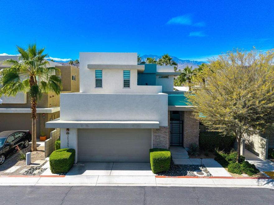 Don't pay new construction prices -- instead, buy in this modern gated community that feels brand new, while enjoying that Palm Springs vibe... without the Palm Springs price tag. Wake up to the majestic San Jacinto Mountains and the soothing sight of mature trees that bring texture, privacy, and shade for those warm desert days. With a 360-degree panorama of mountain vistas, this home was designed to celebrate its stunning surroundings. Your private gated courtyard sets the tone -- peaceful, welcoming, and the perfect spot to enjoy your morning coffee or watch your pets play in the sunshine. Step inside and experience over $70,000 in thoughtful upgrades throughout this open-concept living space. Just move right in. You'll love the cozy fireplace, custom window treatments, and walls of glass that fill the home with natural light. Need a guest room or home office? There's a convenient bedroom and bath downstairs -- complete with generous closet and storage space. Upstairs, retreat to your spacious primary suite with its own private balcony(one of only two in the  community) and spectacular west and southwest mountain views. Enjoy a spa-like shower and an oversized wardrobe closet. Down the hall, another bedroom with a wall of closets opens to a balcony where you can take in more of those unforgettable views. Step outside to your private backyard oasis -- lush landscaping, a sparkling pool, covered patio, and serene views. And when you'd rather not heat your own pool, take advantage of the adjacent community pool and spa. All this just minutes from downtown Palm Springs, the airport, Trader Joe's, and everything the valley has to offer. Why pay more for new construction when you can have this move-in-ready gem -- stylish, modern, and perfectly priced. Your desert Zen lifestyle starts right here. Additional features and upgrades: high ceilings and 24-inch porcelain floor tiles, great room with remote activated fireplace, large dining space, stylish kitchen complete with premium Bertazzoni appliances, quartz countertops, large kitchen island, custom window treatments, a tankless water heater, two-zoned AC system,  extra storage, and direct access two-car garage. Community amenities include a sparkling pool, spa and dog park.