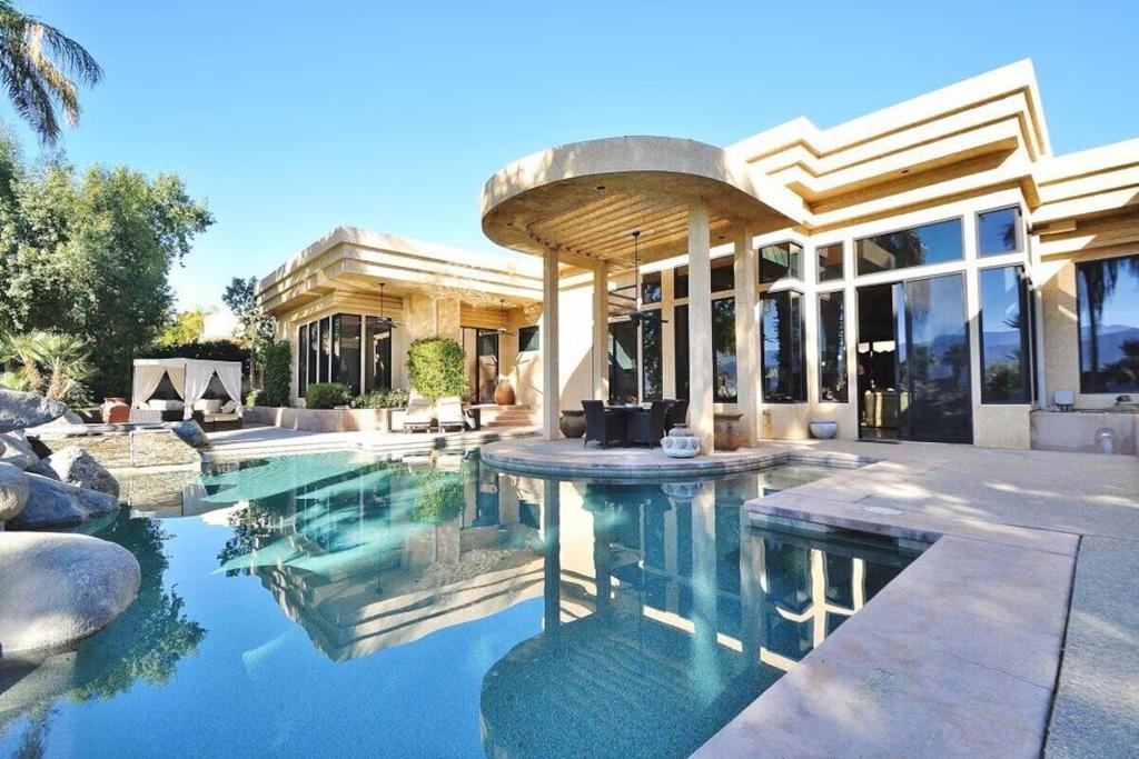 Incredible 6504 SF home on the Green in the exclusive Estates at Desert Springs on the Marriott Desert Springs Golf Course in Palm Desert with south-facing panoramic mountain views and resort-like 1/2 acre backyard Shangri-La with large saltwater pool & spa surrounded by boulders with water fall. Home boasts 5 bedrooms: 3 bedrooms & 2 Casitas each with en-suite bathrooms plus an elegant powder room. This spectacular gem treats you to breathtaking mountain and golf course views. Stay cool with four outdoor ceiling fans, and the outdoor kitchen beckons for BBQ feasts! Venture indoors to discover a grand and spacious haven. High ceilings with charming wood beams set the tone in the great room, featuring floor-to-ceiling windows for natural light and mountain views. The sunken living room boasts Aztec-inspired vibes with a fireplace, sectional sofa, sitting area, and wet bar. The gourmet kitchen is a chef's paradise with granite countertops, a large center island, double ovens, and an oversized pantry. Enjoy the serene surroundings in this turnkey estate. It will be an experience you'll never forget and your friends & family will be beyond thrilled. Close to everything good in the Coachella Valley. Perfect for festival goers & tennis enthusiasts. Equipped with 2 golf carts & bikes. Next available:: May $10,000, June, July & Aug $8500, Sept $10000, Oct $12000, Nov $15000 Dec & Jan: $16000, Feb, Mar & Apr: $18000.