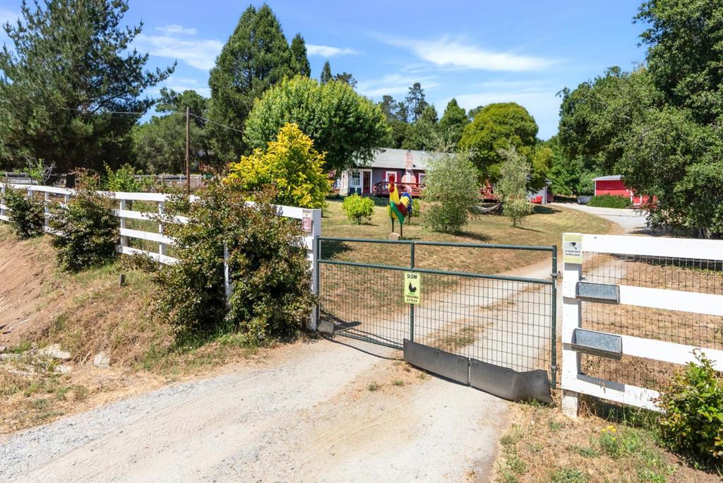 Charming 5+ Bedroom Contemporary Farmhouse, Spectacular Restored Barn & Turnkey Hobby Farm blends rustic elements w/ modern comfort. Nearly one fully usable acre, gated & fenced offers privacy & space for large family. High ceilings & abundance of natural light throughout. Den/Office. Each bedroom boasts access to the outdoors. Kid's playground & their bedrooms w/ ladder to cozy reading nooks. Thoughtfully designed chefs kitchen, large Quartzite stone island, black walnut custom cabinetry, premium appliances, 5-burner cooktop, walk-in pantry. Spacious dining room featuring fireplace for family gatherings. Solar system is owned & paid for, new tankless water heater, ensuring energy efficiency. Relax in Solar-heated exercise pool, outdoor sauna w/ outdoor shower nearby. Detached garage, partly converted to room w/ kitchenette. Raised garden beds and 8 orange, 8 Meyer lemon, 3 apple, 2 walnut, 2 olive trees, as well as figs, cherries, and pomegranates. A chicken coop, goat & duck pen adding self-sustaining charm. Relax, create, play, entertain in style, everything you dream of living in the country. Kitchen qualifies for Class A Cottage Food Operation (CFO) permit- e.g. farm store, direct sales of home-baked, home-grown, maker products to the public.