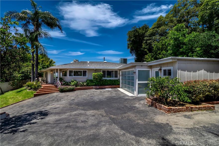 Gated private property in the Mulholland corridor. Jetliner views, swimming pool, basketball court, top-of-the-line property. Perfect for single celebrity. Walls of glass allow for an abundance of natural light throughout this open floor plan. A completely open and airy kitchen that looks out to canyon & mountains, that provide a tranquil setting. The master is a mini suite, with incredible city views, and a walk in closet. Master bath features an exposed glass window that lets in lots of natural light, a sunken tub and a separate shower. The second bathroom also takes in natural light and opens to Incredible city lights. This home is perfect for entertaining. Step out to paradise, the brick patio leads you to a heart shaped pool and spa tub, and of course the most incredible sweeping views of the valley.