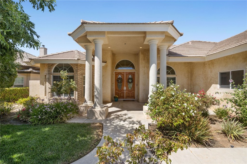 Located in desirable Northwest Bakersfield, this meticulously maintained 4-bedroom, 3-bath home showcases a stunning great room floor plan with soaring 12 & 10 foot ceilings. You'll love the expansive windows overlooking the backyard oasis from the living and kitchen areas. The spacious living area features a welcoming fireplace, while the formal dining room and open kitchen with island, vegetable sink, and breakfast counter make entertaining effortless. A bright breakfast nook adds even more charm. Two bedrooms have a shared full bathroom and walk-in closets. Each of the four bedrooms are designed with privacy in mind with their own individual thermostat control. The luxurious primary suite boasts an oversized walk-in closet for exceptional storage. Step outside to enjoy the covered patio, sparkling inground pool with waterfall, and a sprawling 15,000+ sq. ft. lot. Additional highlights include a 3-car garage and refined details throughout, making this home a true Northwest gem.