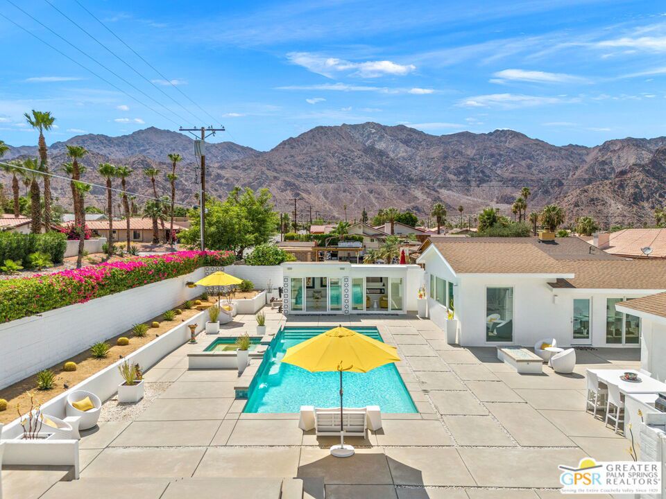 Wow! La Quinta Contemporary on a rare double lot with sweeping mountain views, this fully renovated modern retreat is designed for luxury indoor-outdoor living. A newer custom-designed pool and spa with a series of elegant spillways take center stage, surrounded by a detached casita and multiple conversation areas that frame the pool in style. Decorative mid-century breeze block accents and full perimeter walls create a private, resort-like setting. The home opens through a walled and private front courtyard, offering a peaceful transition into the interiors. Inside, a light-filled great room and chef's kitchen are the heart of the home, featuring Thermador appliances, a six-burner stove, high-gloss custom cabinetry, and a striking oversized island. A series of Milgard double-pane glass sliders open from the main hall and great room to a fabulous outdoor dining area, blending indoor and outdoor living with ease. Tall ceilings are a theme and the layout offers excellent bedroom separation, and both bathrooms have been fully renovated with suspended toilets, sleek vanities, frameless glass showers, and high-end fixtures. Italian tile flooring runs throughout, lending warmth and clean-lined elegance. Finishing touches include a frosted glass entry door, interior frosted bedroom doors, and a custom fiberglass garage door. The detached casita opens directly to the pool through sliding glass doors, offering seamless access and striking views. Inside, it features a wall-mounted fireplace, custom built-in cabinetry with sliding drawers, and a dedicated split A/C systemideal for use as a third bedroom, guest retreat, or private office. The adjacent outdoor shower is a pleasant surprise! And don't miss the upper viewing deck with 360-degree mountain vistas, an outdoor Sonos system, and built-in barbeque area. The fully finished garage includes epoxy flooring, ceiling fan, custom storage, its own split A/C, and a new insulated garage door. Additional upgrades include a water softener system, irrigation, landscape lighting on timers, and newly poured concrete hardscape across the front, back, and sides. Every inch of this home has been thoughtfully curated to offer a rare mix of privacy, modern luxury, and effortless entertaining in one of La Quinta's most stunning settings. Take the Matterport Virtual Tour for a better sense of the layout, flow, and truly special indoor-outdoor connection this home offers.