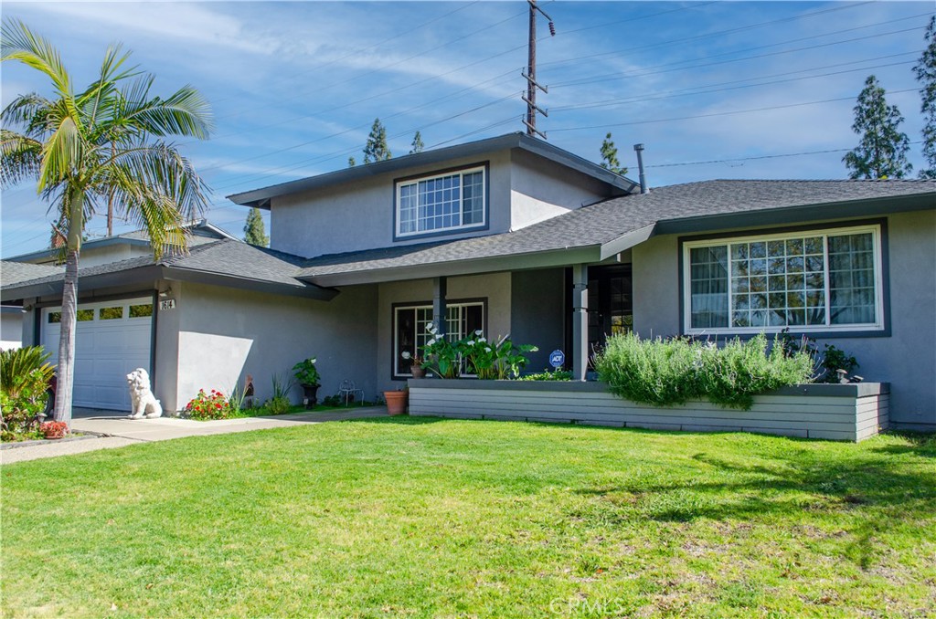 Welcome to Your Dream Home in North Santa Ana! Experience the perfect blend of comfort, style, and modern upgrades in this beautifully refreshed tri-level residence, ideally situated in a peaceful and welcoming North Santa Ana neighborhood. With 5 spacious bedrooms, 2.5 bathrooms, and 2,287 square feet of thoughtfully designed living space, this move-in ready home offers exceptional versatility and value. Enter through double glass front doors into a bright, inviting foyer that leads to a generous living room with a striking flagstone fireplace—ideal for relaxing evenings or entertaining guests. The main-level primary suite provides a private retreat with a walk-in closet and ensuite bathroom, while four additional bedrooms upstairs offer endless possibilities for guest rooms, home offices, creative studios, or fitness spaces. A second full bathroom on the upper level ensures convenience and comfort for all. The heart of the home is the recently remodeled kitchen, featuring rich dark wood cabinetry, granite countertops, and ample storage. The kitchen flows seamlessly into a formal dining room, perfect for hosting dinners and celebrations. Just off the kitchen, a versatile bonus space can serve as a breakfast nook, reading area, or workspace. Enjoy fresh interior paint and new carpeting throughout, creating a stylish, move-in ready atmosphere. There is a brand-new water heater, garbage disposal, dishwasher and electrical panel which supports today’s energy needs. New leased solar panels enhance energy efficiency and help lower monthly utility bills—an excellent feature for those seeking sustainability and savings. Additional highlights include a dedicated indoor laundry room for added convenience. Step outside to a private backyard oasis, complete with a sparkling pool, covered patio, and lush garden area—perfect for outdoor dining, gatherings, or simply unwinding in your own tranquil space. Located just minutes from top-rated schools, parks, shopping, dining, and entertainment, this home offers not just a place to live, but a place to thrive and create lasting memories.