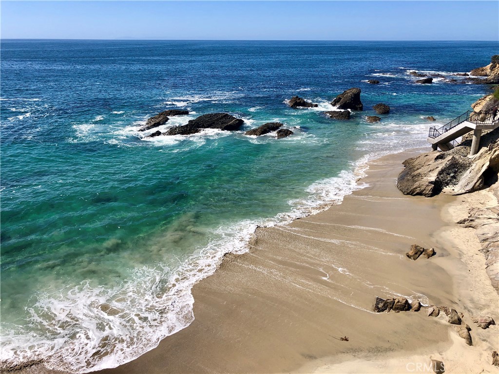 Beautifully remodeled, top-level, corner unit condo with panoramic Ocean and Catalina Island views in charming Wood's Cove. Just a block from the beach entrance, this turn-key, furnished unit has been thoughtfully designed with luxury features and an open floorplan to take advantage of the sweeping Coastline views. Cozy, decorative fireplace and contemporary Bosch decor in the Living Room, New kitchen with all white cabinets, granite counters, and top-quality appliances (instant Induction stove) opens to tasteful Living spaces and ocean view dining. The Primary Suite also has ocean views and large, flat-screen TV. The luxurious bathroom has a large, step-in shower, granite counters, and wood floors. Step out to a covered outdoor patio/deck area with panoramic views. All this, just steps away from Laguna Beach's shops, restaurants, and an easy walk into the Hip District and downtown Village area. Available for short-term (31+ days) and seasonal rentals, please inquire.