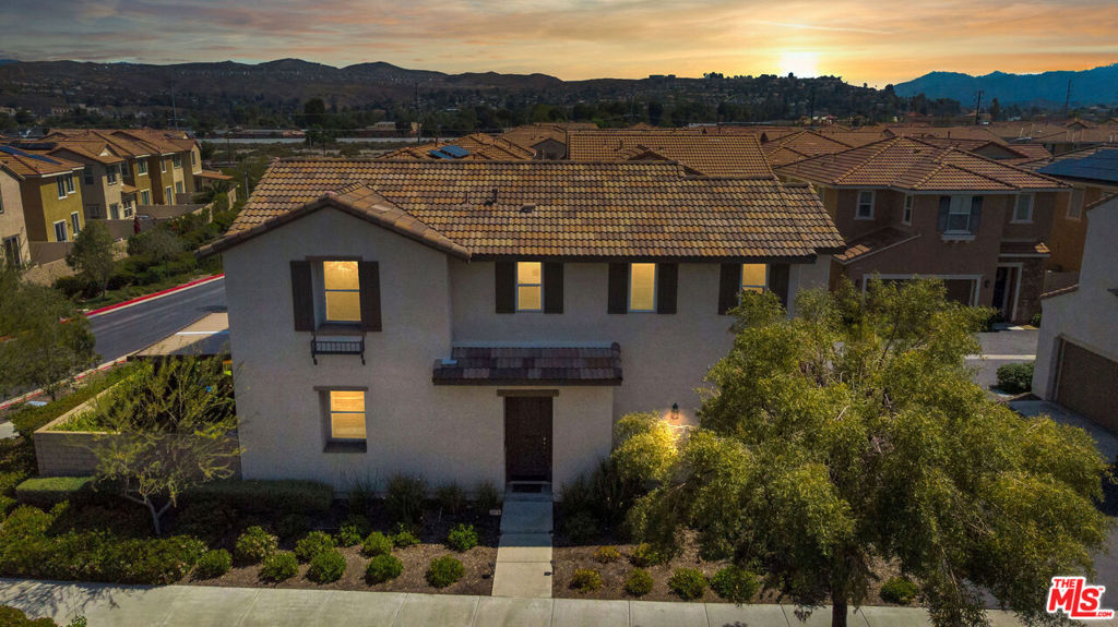 A Rare Corner Lot Gem in the Gated Trestles Community! Welcome to this beautifully upgraded 3-bedroom, 3-bathroom home offering 1,817 sq ft of light-filled living space in one of Santa Clarita's most desirable gated neighborhoods. Built in 2015 and meticulously maintained, this rare corner-lot residence enjoys added privacy with no side-by-side neighbor's unique feature shared by only a select few homes in the community. Step inside and be greeted by laminate hardwood flooring throughout the main level, soaring ceilings, and elegant crown molding that adds a refined touch. The open-concept kitchen features granite countertops, a center island, stainless steel appliances, pendant lighting, and an upgraded dining room fixture perfect for both daily living and entertaining. Upstairs, you'll find laminate flooring throughout, a spacious primary suite with a walk-in closet, and well-appointed secondary bedrooms. Energy-efficient window tinting on the upper floor adds privacy and comfort. The home also includes a large laundry room with utility cabinetry, and shutters throughout.Enjoy outdoor living in the private backyard oasis complete with stamped concrete, turf, a patio cover with shade curtains, and a TV mount for outdoor entertainment. Additional highlights include an electric car charger, tankless water heater, built-in garage storage rack, and direct access to the sparkling community pool, just steps from your door. With no Mello-Roos, easy access to shops, dining, top-rated schools, and the freeway, this is the one you've been waiting for. Don't miss your chance to own one of the most private and well-upgraded homes in Trestles. This home won't last schedule your showing today!