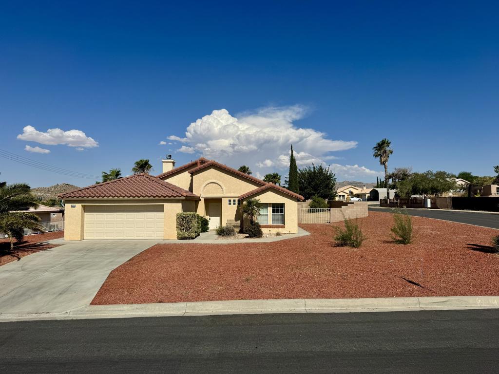 Built in 2002, this 1,448 sq ft, single-level home offers a practical layout and timeless desert appeal. With 3 bedrooms and 2 baths. This residence suits both growing families and those seeking low-maintenance living. A classic fireplace anchors the central living area. Efficient central cooling and an attached two-car garage. The tile roof, sturdy wood-frame construction, and outstanding desert views. Resting on a peaceful 0.28-acre lot with room for a pool. The home is close to schools, local amenities, and open desert landscapes.