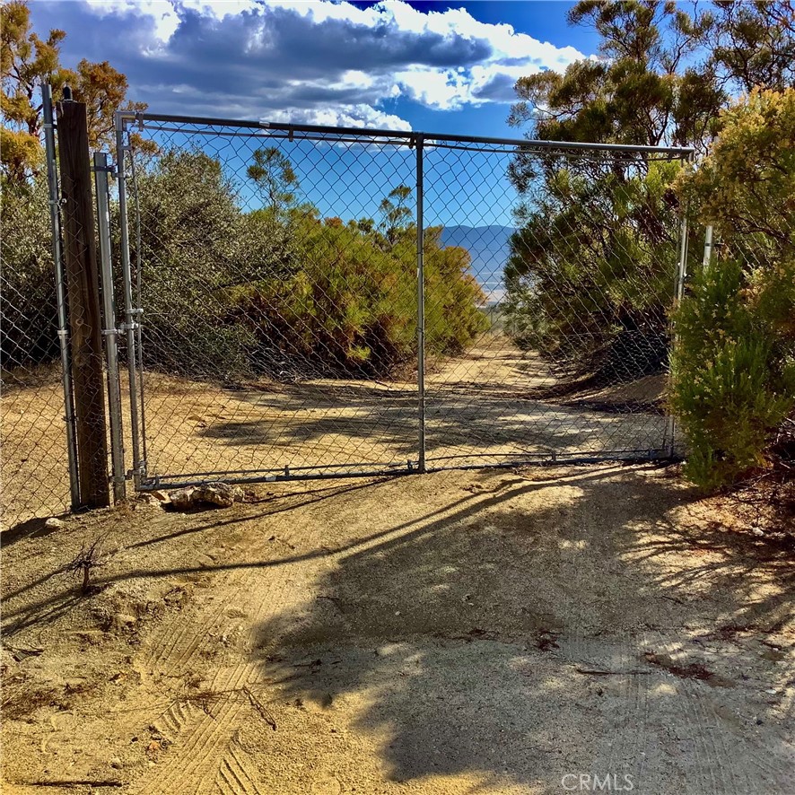 Incredible views of Terwilliger Valley from this 2.27 acre fully fenced and gated lot. 6 ft. chain link fencing surrounds property. 550 ft. deep well. 3,000 gallon water tank and 550 gallon additional water storage. Well house. Chain link fence has 3 feet of galvanized hardware cloth around the bottom of the fence to keep critters out. Cleared pad and roads inside the property. Corners are identified. A Honda 9,000 Watt generator is available for electricity. Very quiet. Area of nice houses and quiet neighbors. Varied topography with lots of native vegetation.