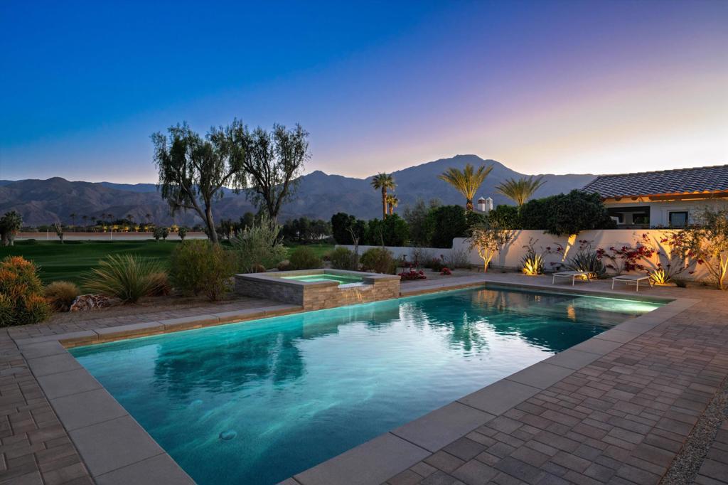 This south-facing gem sits atop the 13th Fairway of the renowned Rees Jones-designed golf course in Andalusia Country Club. Immediately upon entering, your eyes will be irresistibly drawn to pocket doors that open up to reveal dazzling views of the desert landscape framed by the breathtaking panorama of the Santa Rosa and Coral Mountains. Entertaining is a dream in the stunning great room, featuring a wet bar, exposed wood beam ceilings, and flawless porcelain tile flooring throughout. The gourmet kitchen is a culinary masterpiece, outfitted with state-of-the-art appliances, custom glass-front cabinets, and Caesarstone countertops. The expansive primary suite is nothing short of spectacular, offering a luxurious soaking tub, soothing fireplace, and generous custom closets. Guests will feel perfectly at home in the private, detached two-room casita. The backyard is a private oasis, with a built-in BBQ, firepit, custom 40-foot pool, outdoor heaters in the loggia, and a raised spa with water feature--perfect for soaking in the glow of picturesque desert sunsets. The home has an abundance of upgrades including solar panels, a central vacuum system, and epoxy-coated garage floors. Come live the life you've always imagined!