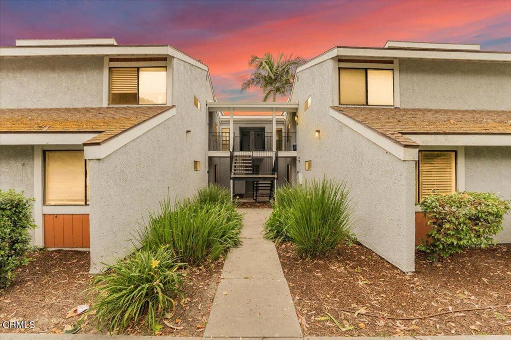 Opportunity to acquire a well-appointed starter home. This attractive two-bedroom, one-bath upper-level condominium is situated within the Pleasant Valley Forest Condominium Community. The end-unit features updated Venetian blinds, shutters, fixtures, laminate flooring, fresh paint, base moldings, and a recently renovated bathroom with floor-to-ceiling tile and a new vanity. The spacious living room offers soaring vaulted ceilings and abundant natural light through multiple skylights. Additional features include a private balcony with views of the mountains and agricultural fields, a functional kitchen, and a well-maintained interior. The property also includes two enclosed one-car garages with dedicated laundry areas. Currently, this is the most competitively priced condo in Oxnard offering enclosed garages and personal laundry facilities.