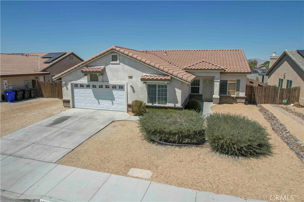 Beautiful Home! Fresh coat of paint! Centrally located and less than 5 minutes away from freeway and your favorite amenities such as schools, shopping, parks, & gyms. The exterior features has low maintenance rockscaping and main door walkway hardscaping. The interior has two tone paint, vaulted ceilings, and plenty of natural lighting. The kitchen has granite countertops, long bar, & open to the family room which features a caddie corner tile fireplace. The master suite has private access to back yard, custom ceiling, duo sinks, large walk in closet, & custom shower enclosure. Rooms are spacious & garage is completely finished.