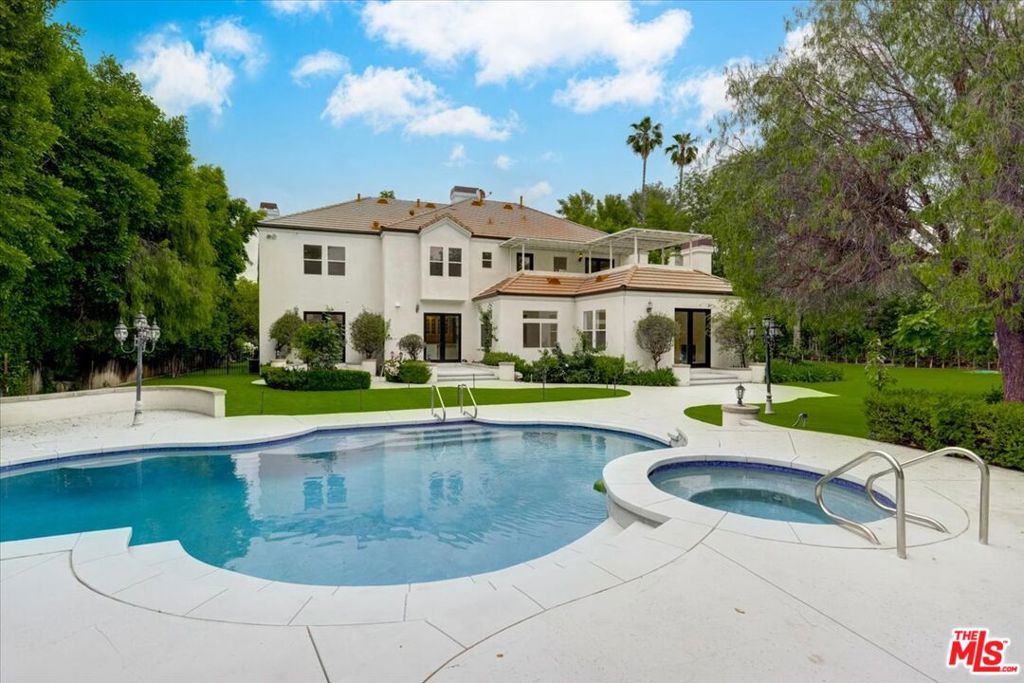Exquisite massive gated estate located in the coveted Tarzana neighborhood SOUTH of Ventura Blvd. Welcome to this REMODELED 8 bed 9.5 bath, OVER 8,100+ sqft home on an over a 30,000ft lot, w/ an ELEVATOR. This PRIVATE home feels like a compound. SEPERATE guest quarters w/ full kitchen, a dining area & a large bedroom suite w/ its own a private entrance from the outside. Features include a luxurious primary bedroom, w/ sitting area, spa like bathroom & large walk-in closet. Motor court can park 8 cars comfortably, 4 car garage & the home has park like features w/ sprawling turf for entertaining. Oversized family room w/ double French doors leads you to the backyard. Enormous kitchen w/ massive island, stainless steel appliances, double dishwashers & subzero fridge. A large balcony upstairs overlooking lush wrap-around back yard features kids playing are, pool, spa, sport court/ BASKETBALL COURT, CABANA to add Billiards table, w/ bathroom, shower, changing room for your guests. A true one-of-a-kind estate, near fine dining, shopping, freeways & more. DON'T MISS OUT ON THIS OPPORTUNITY. A MUST SEE!!!