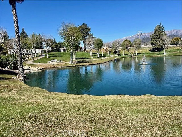 Spacious 2-bedroom, 2-bathroom home in the 55+ community of The Plantation on the Lake in Calimesa. At 1,646?sq?ft, this manufactured home features an open floorplan with large east-facing windows that fill it with natural light. The layout includes a versatile den area ideal for an office or hobby space. Outdoors, a generously sized backyard with mature trees provides a relaxing green setting. Residents enjoy community walking paths, green spaces, and scenic lake surroundings in a peaceful, resort-style environment. An attached 2-car garage offers convenient parking