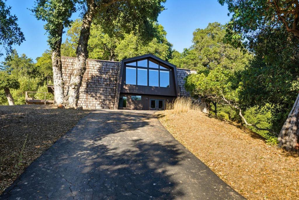 This home has something for everyone! WANTING AN AMAZING MOUNTAIN RETREAT? Look no further than this incredible architectural gem with its open floor plan, incredible vaulted open-beam ceilings, four spacious bedrooms on over 3.3 acres of privacy, beauty, and timeless design. LOOKING FOR ECO FRIENDLY? Go green with this fully electric home that is ready for solar powered off-grid living. SEEKING A RENTAL, ADU OR MULTI-GENERATIONAL COMPOUND? Then the expansive detached 3 garage/workshop with water, power and dedicated septic is primed for expansion/ADU conversion. ARCHITECTURE TOP IN YOUR LIST? Your guests will be wowed by walls of glass, soaring vaulted ceilings, and an open-concept layout bathe the home in natural light, providing an indoor-outdoor flow and a sense of spacious tranquility. TOP SCHOOLS? This home is served by top Rated Loma Prieta and Los Gatos Schools, offering some of the best public school education in the area. Not mention, private school options are available on both the Santa Cruz and Los Gatos sides of the mountain. PRIVACY? The long private driveway meanders through gorgeous oaks, providing for tremendous privacy. AND THE VIEWS?Vistas are plentiful from one of the many windows, patios or from the completely private and sun-drenched swimming pool.