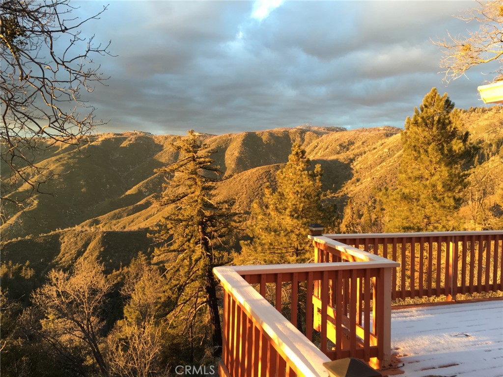 Imagine a charming mountain retreat with three spacious bedrooms and three bathrooms. Perfect for a family or guests. This home also features a convenient two-car attached garage. Nestled in the mountains, you'll enjoy breathtaking canyon views right from your back deck, offering a peaceful and picturesque backdrop to your daily life. Home sits on a large 22,672 square foot lot with level entry. Open living room with cathedral ceiling and bedroom and bath on main level, with cozy fireplace. Downstairs 2 bedrooms and 2 more baths with family room and gas stove fireplace. Close to ski resorts, hiking, the famous Sky Park for adventure and much more.