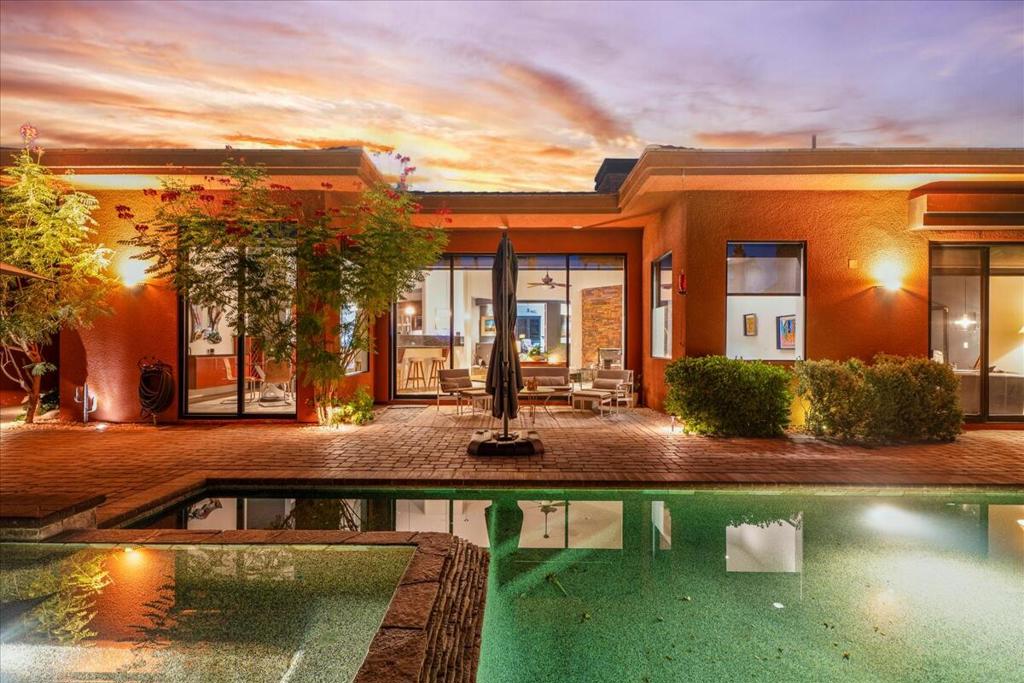 Elegant & ExclusiveStep into refined desert elegance at 50325 Via Amante, a stunning Palmilla retreat that defines luxury living in La Quinta.This exceptional single-story contemporary home with a detached casita, perfectly blends modern design with the serenity of resort-style surroundings.Step through the grand entryway into a dramatic Great Room with soaring ceilings and floor-to-ceiling pocket glass doors that seamlessly frame breathtaking views and lead to the backyard retreat. The open-concept design connects the living, dining, and chef's kitchen areas, enhanced by custom slate floors and refined designer finishes.The gourmet kitchen is beautifully appointed with granite countertops, a spacious island, double ovens, and premium appliances. A sleek wet bar off the Great Room enhances the home's entertainment appeal, while a private office or study behind double doors provides the perfect space to work or unwind in quiet comfort.The primary suite is a true sanctuary, offering a sitting area overlooking the pool, two walk-in closets, and a luxurious spa-style bath with dual vanities, a soaking tub, and a glass-enclosed stone shower. Two additional guest suites and a detached casita each offer their own ensuite baths--perfect for hosting family or friends with style and privacy.Outside, the home becomes a true desert oasis. Enjoy a saltwater Pebble Tec pool with cascading water features, a stacked-stone spa, multiple lounging and dining areas, and a built-in BBQ/outdoor kitchen. Expansive glass doors allow for effortless indoor-outdoor living, while motorized shades provide easy control over light and privacy.Located within Palmilla's 24-hour guard-gated enclave, residents enjoy both peace of mind and convenience--just minutes from La Quinta's world-class golf courses, hiking trails, fine dining, and resort destinations.With its elegant design, thoughtful floor plan, and exceptional setting, this home stands out as a perfect blend of style, comfort, and desert sophistication. Don't miss your opportunity to own one of Palmilla's finest properties.