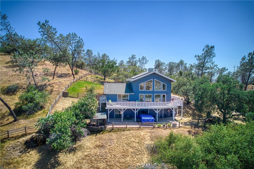 Nestled on approximately 24.71+/- serene ac., this stunning 3-level custom home is a dream come true for equestrians & nature lovers alike. Perched on a gentle rise, it offers panoramic views of rolling meadows, oaks, pines, & your own fully-equipped horse facilities. Designed for comfort & functionality this 4-bedroom, 3.5-bath home masterfully blends rustic charm with modern convenience. Soaring ceilings & expansive picture windows fill the living room with natural light. The open-concept kitchen & dining area offer even more scenic views, along with a walk-in pantry, a center island with breakfast bar, & ample storage. The spacious primary suite features direct access to a private deck, a large walk-in closet, and a luxurious en-suite bath, a soaking tub, & a separate walk-in shower. The newly completed lower-level apartment adds valuable flexible living space, featuring a full bed/bath, & generous family room ideal for guests, extended family, or rental potential. Just outside, a private swim spa provides the perfect spot to unwind. Property is fenced/cross fenced. Equestrians will appreciate the thoughtfully designed 8-stall barn, complete with rubber mats, a foaling stall, wash station, tack room, & spacious storage loft. The 180' x 100' all-weather arena is equipped with lights & sprinklers, offering the perfect environment for dressage, jumping, trail obstacles, or young horse development. Separate hay barn includes electrical service & enclosed storage room.