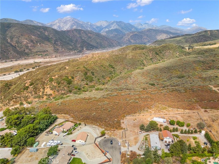 Welcome to 5.55 acres of panoramic opportunity in the hills of Devore! This expansive parcel is located just beside another available 3.79-acre lot (also for sale) and presents a unique chance to acquire over 9 acres total in one of San Bernardino County’s most scenic and secluded pockets. Situated at the end of a peaceful cul-de-sac, this buildable lot is ideal for a custom home, rural retreat, or future investment. Enjoy breathtaking views of the valley, mountains, and city lights—all just minutes from major freeways, shopping, and restaurants. Electricity and water are available at the street (buyer to verify). Whether purchased on its own or in tandem with the neighboring parcel, this land represents a rare blend of privacy, accessibility, and long-term potential.