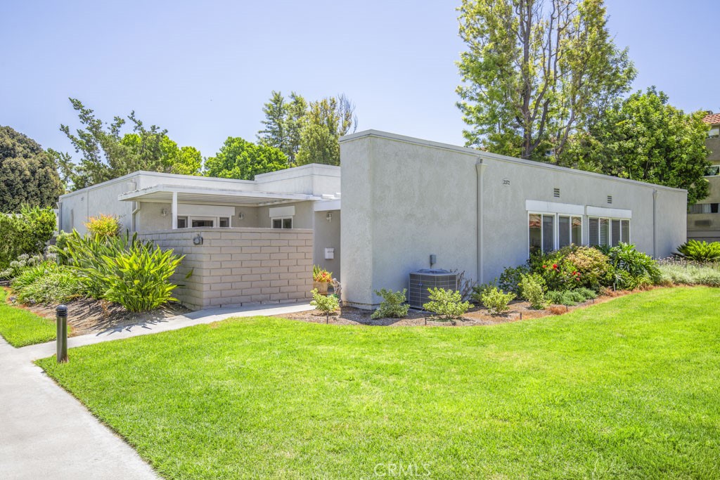 Welcome to 2372-B Via Mariposa – a lovely single-level, fully-remodeled two-bedroom, two-bath NEW VALENCIA residence in the active Laguna Woods senior community. The walled private partially-covered entry patio is a terrific setting for year-round outdoor entertaining, dining or relaxing. The patio has two large closets for additional storage. The gorgeous custom front door with stylish glass inserts opens to the living room with large windows that flood the room with sunlight throughout the day. The original central atrium has remained intact and provides an additional private outdoor space. The kitchen features granite countertops, newer cabinetry, an attractive tile backsplash, stainless steel appliances (including an LG fridge and Bosch dishwasher), a built-in trash/recycling drawer and a breakfast bar that comfortably seats two. The kitchen window overlooks the front patio. The primary bedroom has mirrored closet doors and direct access to the front patio. The guest bedroom could also serve as a workout room, arts and crafts studio, reading room or home gym. Both primary and guest bathrooms have showers with grab bars and accessory shelves. (The guest bathroom has a tub/shower combo). Both feature newer cabinetry with granite countertops. Upgrades throughout the home include smooth ceilings, crown molding, recessed lighting, dual-pane windows and central heat and air. A full-size stackable washer-dryer is conveniently situated in a hall closet. The nearby carport has both upper and lower storage cabinets. There is ample guest parking in the large cul-de-sac. Clubhouse Four with a large pool and hot tub along with a variety of arts and crafts studios is a short walk or drive away. This is a gorgeous home. Do not miss!