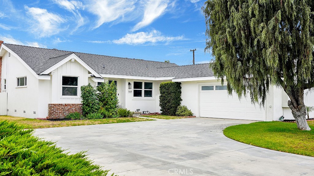 Welcome to this beautifully maintained single-story ranch-style home, offering comfort, functionality, and a fantastic location. Inside, you’ll find an inviting living room filled with natural light, featuring a cozy gas-burning fireplace and direct access to the expansive backyard—perfect for entertaining or relaxing. The mid-century modern kitchen blends character with functionality, and next to it is a spacious dining nook, ideal for casual meals or hosting guests. Newer windows throughout the home add energy efficiency and brightness. The thoughtful floor plan includes a private primary suite with a walk-in shower on one side of the home, and two additional bedrooms on the other, providing privacy for family or guests. Ample closet space is found throughout, along with a dedicated laundry room for convenience. Step outside to a shaded patio overlooking a lush, spacious lawn adorned with fruit trees and vibrant plumerias—ideal for gardening, outdoor dining, or simply enjoying the fresh air. Additional highlights include a newer roof, and a two-car garage with driveway. Located near major freeways and just minutes from Disneyland, Angel Stadium, the Anaheim Convention Center, and an array of local attractions, this home offers the perfect balance of comfort and connectivity to everything Orange County has to offer!