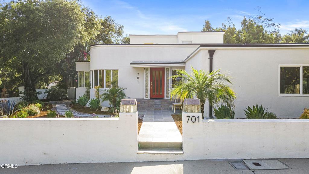 With an enviable location at the upper end of Canada St just blocks from downtown Ojai, this one of a kind 4 bedroom 4 bath Art Deco home features curved lines with a Mid Century feel. Upon entering you are greeted with ample windows allowing natural light to filter in. A gourmet kitchen opens up to the generous living room and dining room area equipped with a cozy fireplace and french doors leading out to the spacious backyard. Upstairs you will find a separate guest wing with its own private rooftop patio to enjoy the mountain views. Situated on .38 acres with decks for lounging, fruit trees, a fountain and mature landscaping. Additional features include a detached 2 car garage and an outdoor BBQ area. A true retreat in the heart of Ojai!