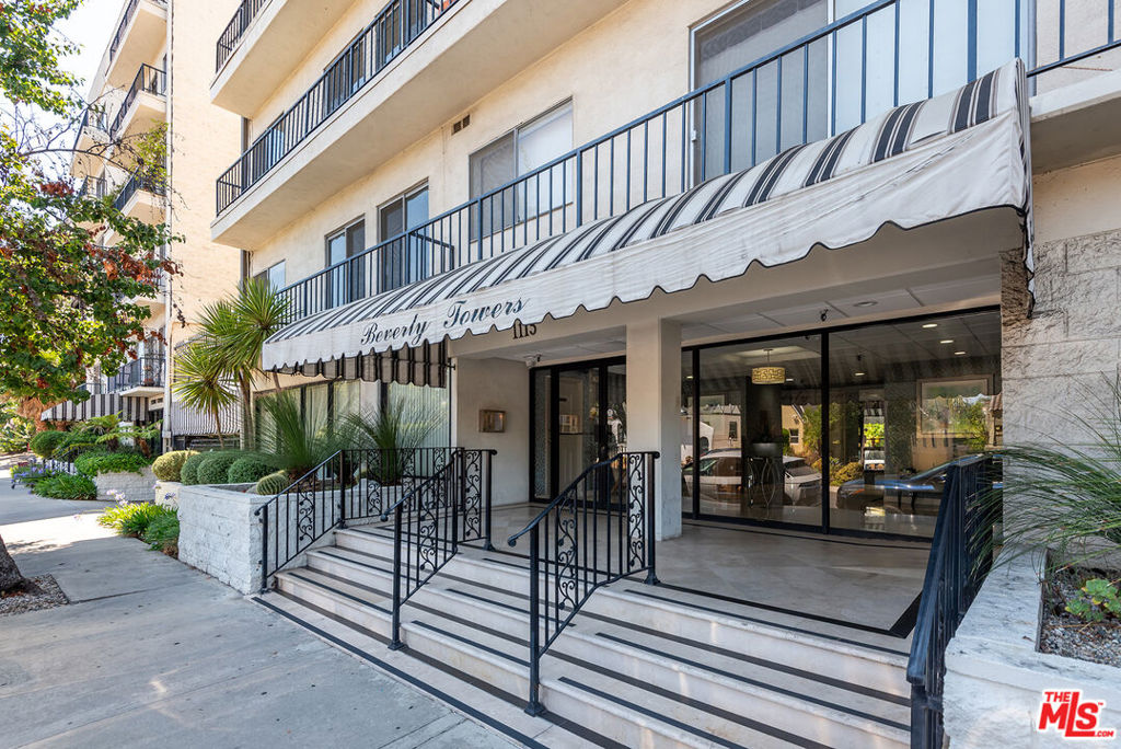 Bordering Beverly Hills, in the vibrant and centrally located Pico-Robertson neighborhood, this fourth floor, light infused 2-bedroom, 2-bathroom residence at Beverly Towers offers an exceptional opportunity at an accessible price point. The open-concept layout features hardwood floors, warm wood cabinetry, granite and tile finishes, and expansive sliding doors that frame sweeping views from the Hollywood Hills to Downtown Los Angeles. The spacious primary suite includes dual walk-in closets and a private en-suite bath. Beverly Towers offers resort-style amenities including a swimmer's pool, in-ground spa, gym, sauna, elegant lobbies, and on-site management, all with very reasonable HOA fees. Two tandem parking spaces in a gated garage and a private storage locker are included, and the building is within the highly rated Canfield Elementary School district.
